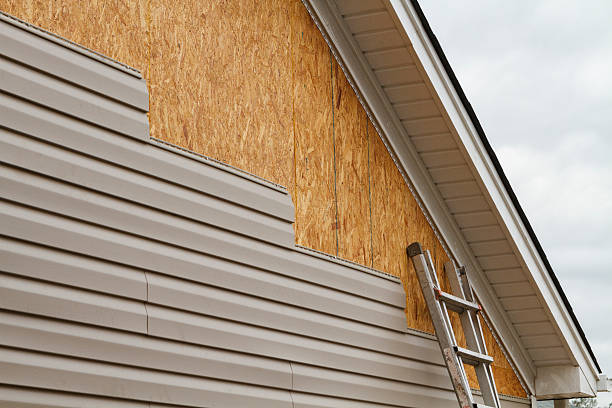 Professional Storm Damage Siding Repair technician working in Houtzdale, PA